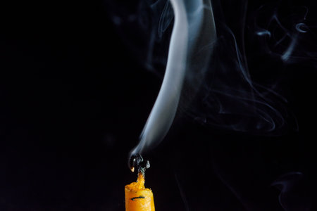 Smoke from a candle on a black background, close-upの写真素材