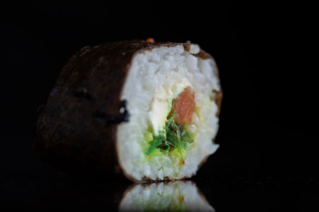 Sushi roll on a black background with reflection. Japanese food.の写真素材