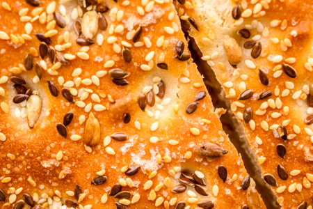 Close up of freshly baked bread with sesame seeds. Whole background.