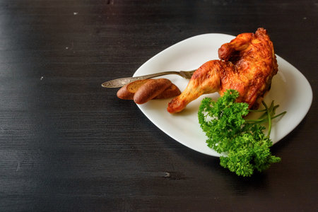 fried chicken on a white plate on a dark wooden backgroundの写真素材