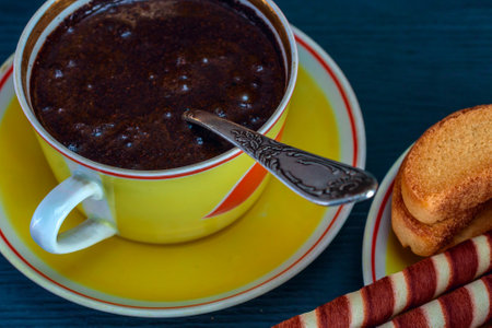 Cup of hot chocolate with toasted bread on dark wooden backgroundの写真素材