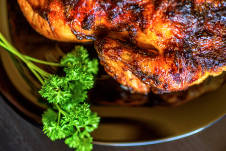 baked chicken on a dark wooden background.の写真素材