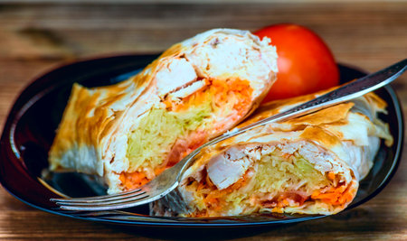 Cabbage strudel with chicken and carrots on a wooden tableの写真素材