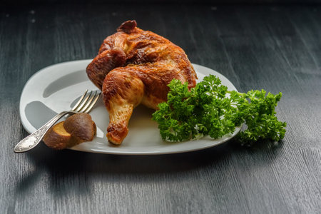 fried chicken on a white plate on a dark wooden background