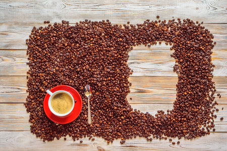 a cup of coffee on a background of coffee beansの写真素材