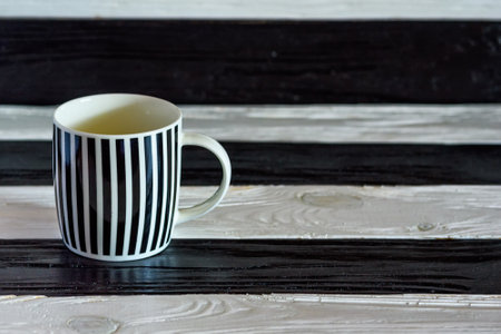 black-and-white ceramic cup on a wooden backgroundの写真素材