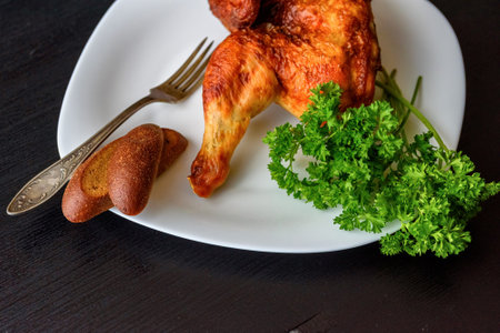 fried chicken on a white plate on a dark wooden backgroundの写真素材