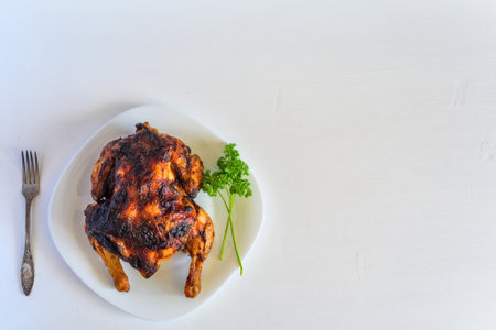 fried chicken on a plate on a light backgroundの写真素材