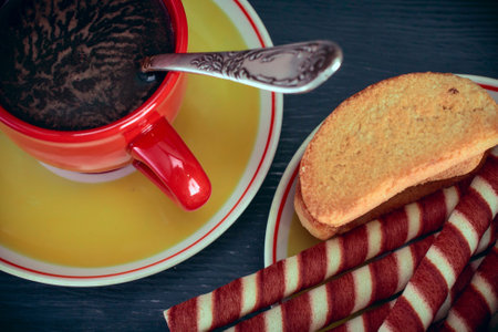Cup of coffee and cookies on wooden background. Toned.の写真素材