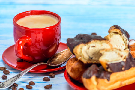 Cup of coffee and croissants with chocolate on a blue wooden backgroundの写真素材