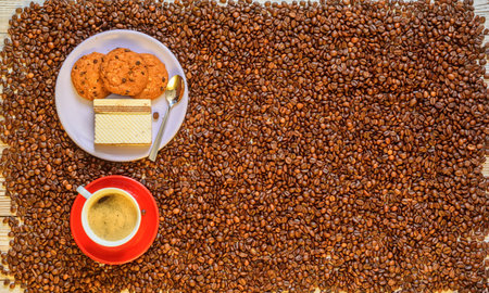 cup of coffee and homemade cookies on the background of coffee beansの写真素材