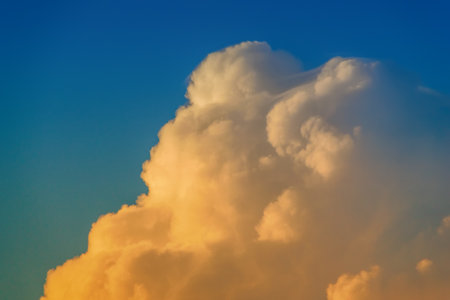 fluffy clouds against the skyの写真素材