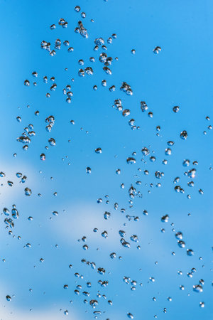 drops of a fountain against the skyの写真素材