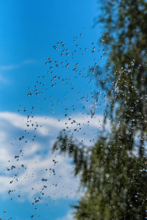 drops of a fountain against the skyの写真素材