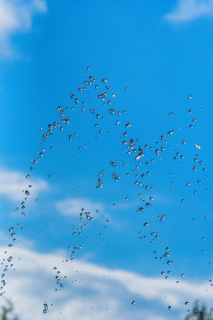 drops of a fountain against the skyの写真素材