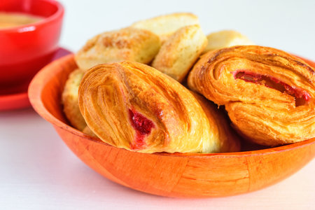 Puff pastry with jam on a white wooden backgroundの写真素材