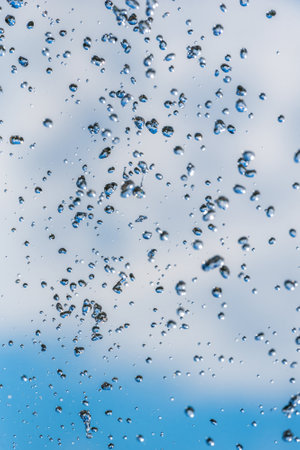 drops of a fountain against the skyの写真素材