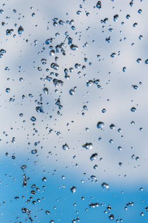 drops of a fountain against the skyの写真素材