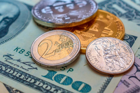 Dollars and coins of different denominations on a background of dollarsの写真素材