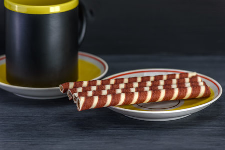 waffle rolls with tea on a dark background, close-upの写真素材