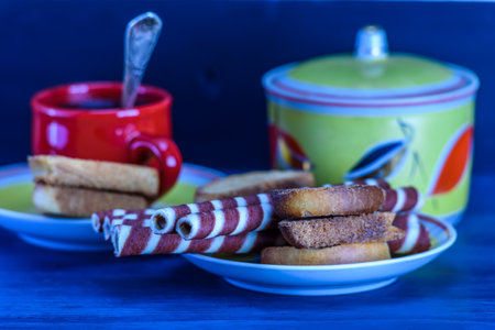 Cup of coffee and cookies on a blue wooden background. Selective focus.の写真素材