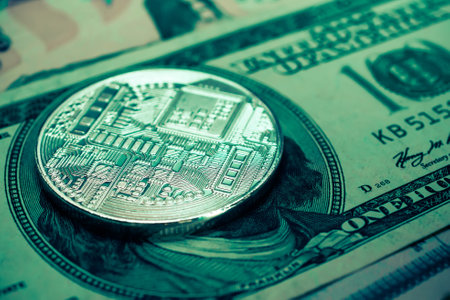 Digital currency physical metal bitcoin coin on dollar banknotes. Cryptocurrency concept.の写真素材
