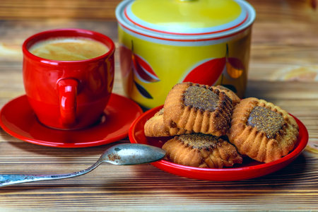 Cup of coffee with cookies on a wooden background, selective focusの写真素材