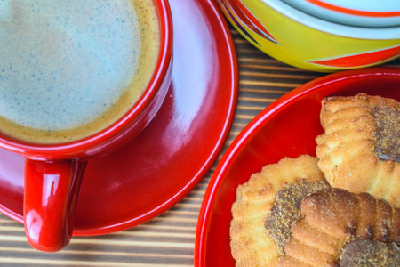 Cup of coffee and cookies on a wooden table, top viewの写真素材