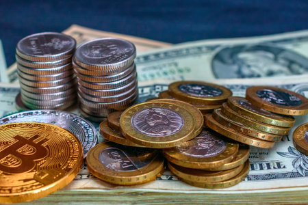 Coins on the background of dollar bills, close-up.の写真素材