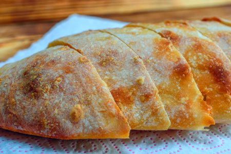 Focaccia bread on a napkin on a wooden tableの写真素材