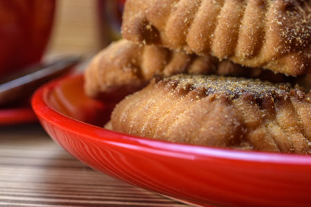 Close up of homemade cookies in red plate on a wooden table.の写真素材