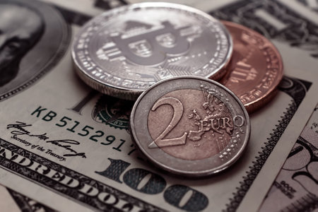 Coins on the background of one hundred dollar bills, close-up