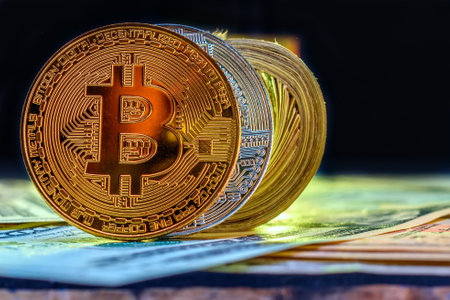 Golden bitcoin on the background of dollar bills. Close-up.