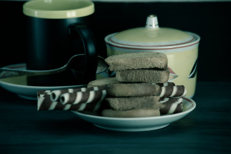 Coffee cup and cookies on wooden table. Toned.の写真素材