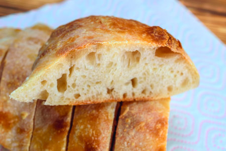 Slices of ciabatta bread on a tableclothの写真素材