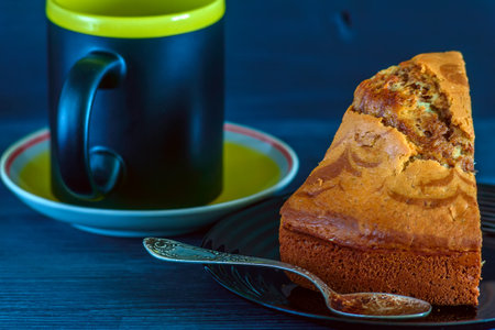 Coffee cup and cake on blue wooden table, stock photoの写真素材