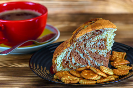 Cup of coffee and cookies on a plate on a wooden backgroundの写真素材