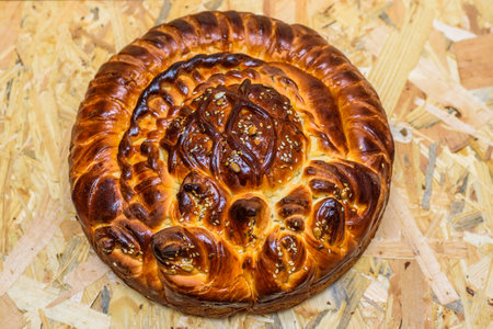 Traditional Georgian bread kulich on a wooden background.