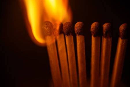Burning matchsticks on a black background. Close-up.