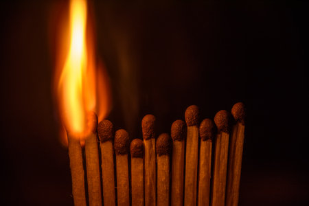Wooden matches burning on a black background. Close-up.の写真素材