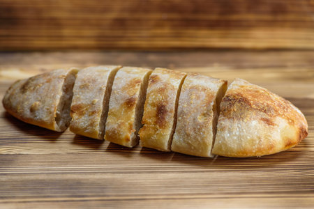 Sliced bread on a wooden table.