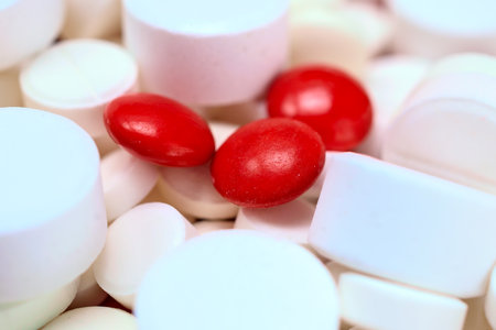 Close-up of red and white pills on a white background.の写真素材