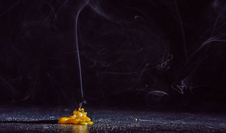 Candle end on a dark background.の写真素材