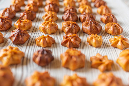 Choux pastry on a light wooden background. Photographed close-up.の写真素材