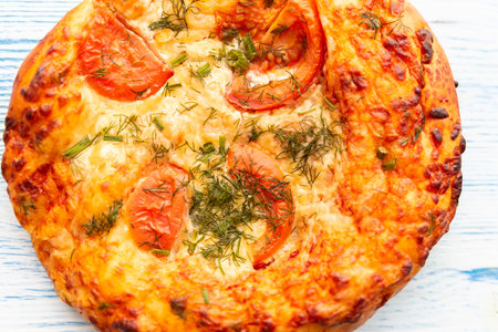 Pizza with cheese and tomatoes. Photographed close-up.の写真素材