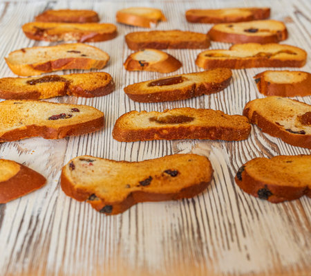 Wheat rusks on a wooden background. Background from rusks. Photographed close-up.の写真素材