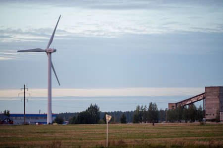 Beautiful sunset above the windmills on the field