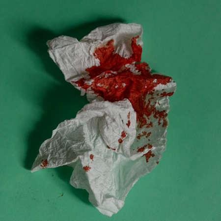 Blood on the hygiene napkin Bloody wound Skincare mockup for design Stack of disposable napkins on a blue backgroundの写真素材