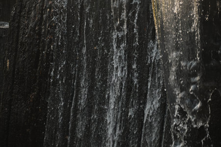 A waterfall flowing at park Wall of water A beautiful view of the falling water cascade city...