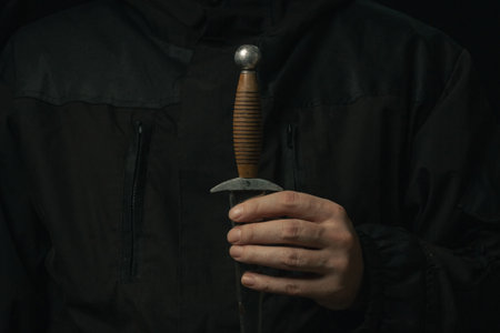 hand holding medieval antique dagger knife